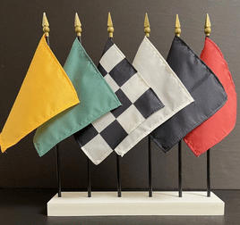 a photo of six miniature racing flags set in a white rectangular stand